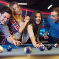group-of-young-friends-playing-billiard-e1640711468961.jpg